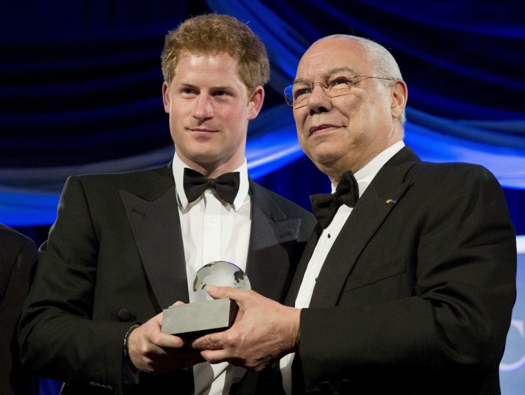 Image: Britain's Prince Harry stands with former U.S. Secretary of State Colin Powell as he receives the Humanitarian Award from the Atlantic Council during their annual awards dinner in Washington